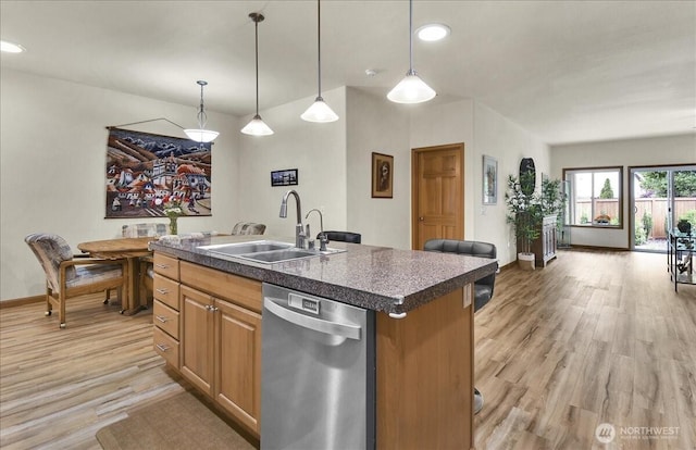 15203 148th Avenue Ct E, Orting, WA 98360 - kitchen featuring stainless steel dishwasher, light wood finished floors, dark countertops, hanging light fixtures, and recessed lighting