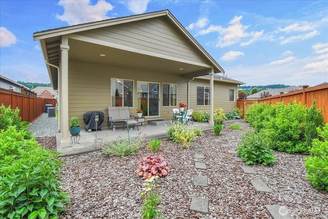 15203 148th Avenue Ct E, Orting, WA 98360 - rear view of property with a patio area and a fenced backyard