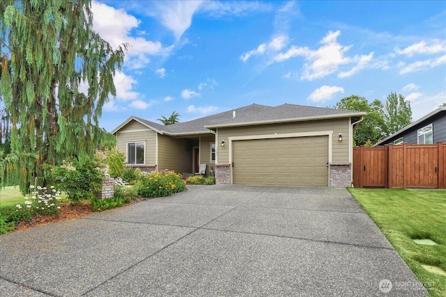 15203 148th Avenue Ct E, Orting, WA 98360 - view of front facade featuring brick siding, driveway, and a garage