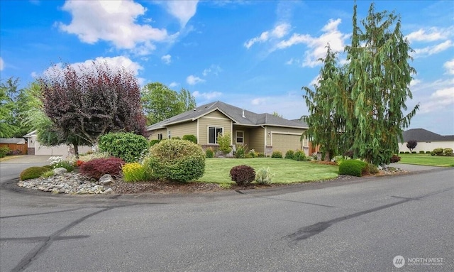 15203 148th Avenue Ct E, Orting, WA 98360 - single story home with driveway, an attached garage, and a front lawn