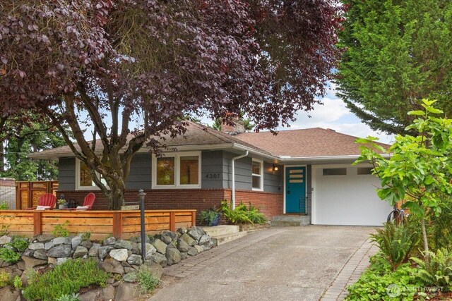 4301 1st Ave NW, Seattle, WA 98107 - ranch-style house with asphalt driveway, an attached garage, a chimney, brick siding, and a shingled roof