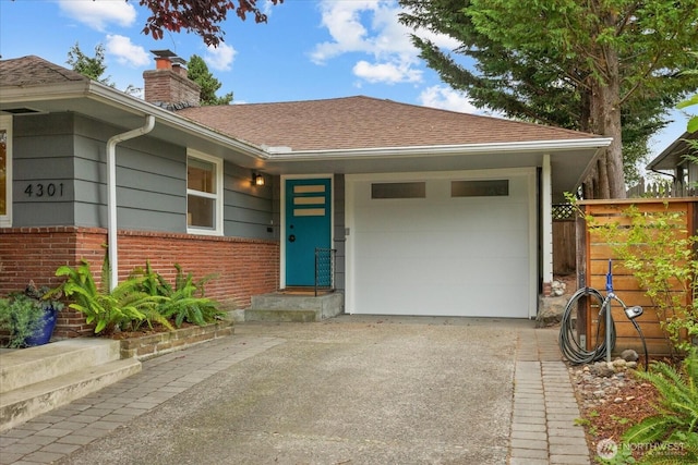 4301 1st Ave NW, Seattle, WA 98107 - view of front of property with driveway, a chimney, brick siding, a garage, and roof with shingles