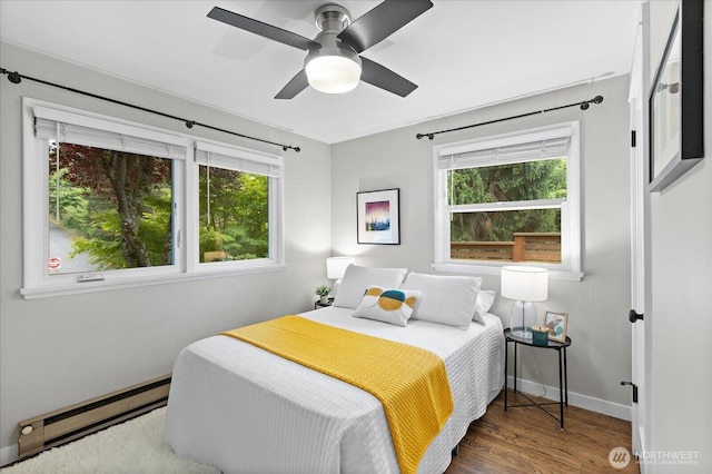 4301 1st Ave NW, Seattle, WA 98107 - bedroom with a baseboard heating unit, wood finished floors, and ceiling fan