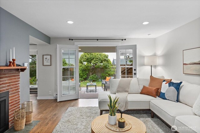 4301 1st Ave NW, Seattle, WA 98107 - living area with healthy amount of natural light, wood finished floors, recessed lighting, and a brick fireplace