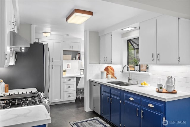 4301 1st Ave NW, Seattle, WA 98107 - kitchen with stainless steel appliances, backsplash, blue cabinetry, white cabinets, and light stone counters