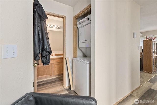 2826 NE 8th St, Renton, WA 98056 - washroom with stacked washer / dryer and wood finished floors