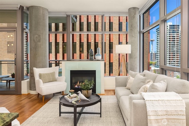 2033 2nd Ave Unit 703, Seattle, WA 98121 - living room featuring wood finished floors and a glass covered fireplace