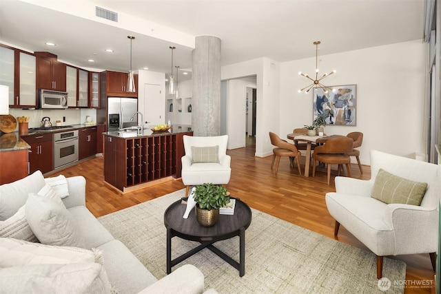 2033 2nd Ave Unit 703, Seattle, WA 98121 - living area with a chandelier, light wood-style floors, and recessed lighting