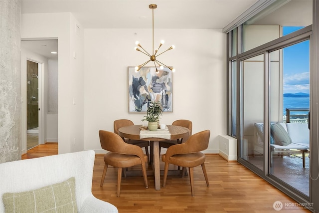 2033 2nd Ave Unit 703, Seattle, WA 98121 - dining space featuring a chandelier and light wood-style floors