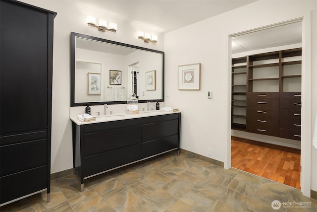 2033 2nd Ave Unit 703, Seattle, WA 98121 - bathroom featuring double vanity and stone finish floors