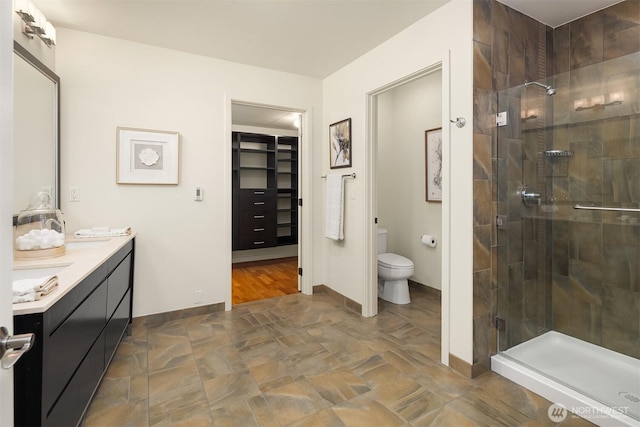 2033 2nd Ave Unit 703, Seattle, WA 98121 - bathroom featuring a stall shower, double vanity, and a spacious closet