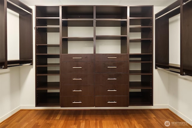 2033 2nd Ave Unit 703, Seattle, WA 98121 - walk in closet featuring wood finished floors
