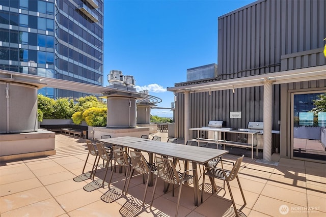 2033 2nd Ave Unit 703, Seattle, WA 98121 - view of patio featuring outdoor dining space and exterior kitchen