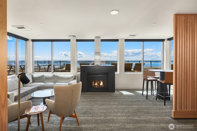 2033 2nd Ave Unit 703, Seattle, WA 98121 - living area featuring carpet floors and a warm lit fireplace
