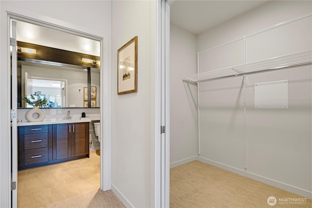 1760 NW 56th St Unit 520, Seattle, WA 98107 - walk in closet featuring a sink and light colored carpet