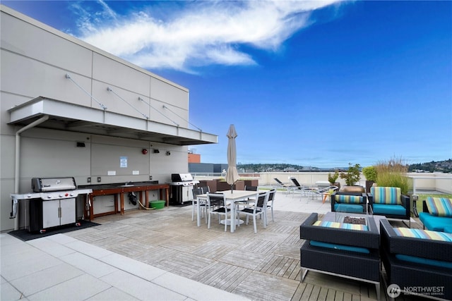 1760 NW 56th St Unit 520, Seattle, WA 98107 - view of patio featuring a grill, outdoor dining space, and a fire pit