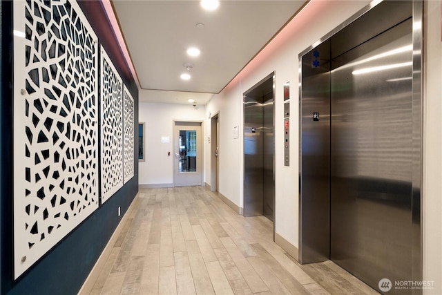1760 NW 56th St Unit 520, Seattle, WA 98107 - hall with elevator, light wood-style flooring, and recessed lighting