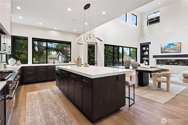 5515 108th Ave NE, Kirkland, WA 98033 - kitchen featuring plenty of natural light, light countertops, a kitchen island, recessed lighting, and a high ceiling