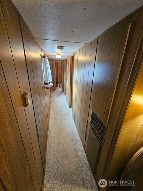 3906 L Pl, Seaview, WA 98644 - hallway with a textured ceiling and wooden walls