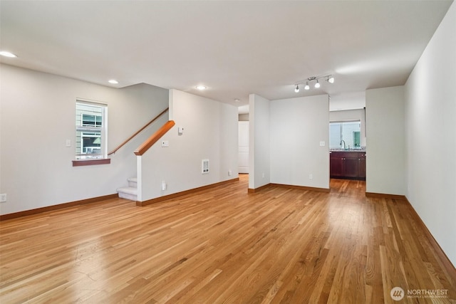 9211 Ashworth Ave N Unit B, Seattle, WA 98103 - unfurnished living room with light wood-type flooring, stairway, and recessed lighting