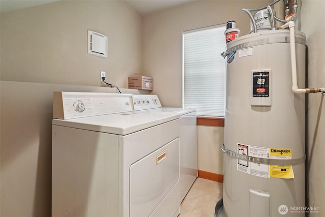 9211 Ashworth Ave N Unit B, Seattle, WA 98103 - laundry area featuring strapped water heater, separate washer and dryer, and light tile patterned flooring