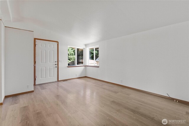 12407 Prairie Ridge Dr E, Bonney Lake, WA 98391 - spare room with light wood-style flooring and lofted ceiling