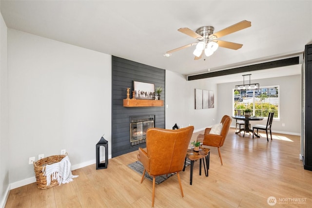 2141 Jason Ct, Ferndale, WA 98248 - dining area with a large fireplace, light wood-type flooring, a ceiling fan, a chandelier, and beam ceiling