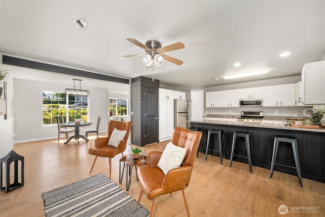 2141 Jason Ct, Ferndale, WA 98248 - kitchen with appliances with stainless steel finishes, white cabinets, recessed lighting, light wood-type flooring, and a peninsula