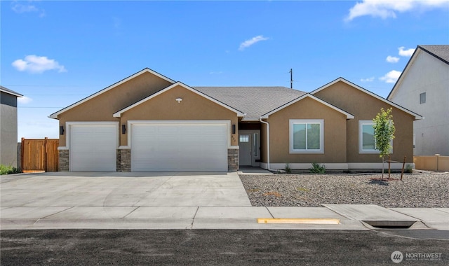 832 Q St SW, Quincy, WA 98848 - ranch-style house featuring stucco siding, a garage, stone siding, and driveway