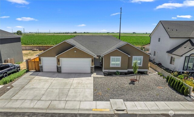 832 Q St SW, Quincy, WA 98848 - ranch-style house with an attached garage, stucco siding, concrete driveway, and stone siding