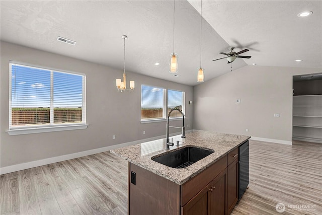 832 Q St SW, Quincy, WA 98848 - kitchen with open floor plan, light wood finished floors, lofted ceiling, ceiling fan, and pendant lighting
