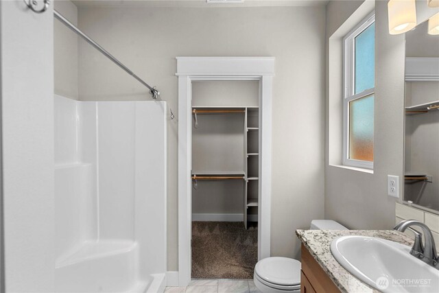 832 Q St SW, Quincy, WA 98848 - full bathroom featuring a shower, vanity, healthy amount of natural light, and a walk in closet