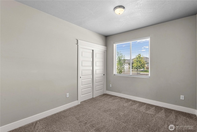 832 Q St SW, Quincy, WA 98848 - unfurnished bedroom with carpet floors, a closet, and a textured ceiling