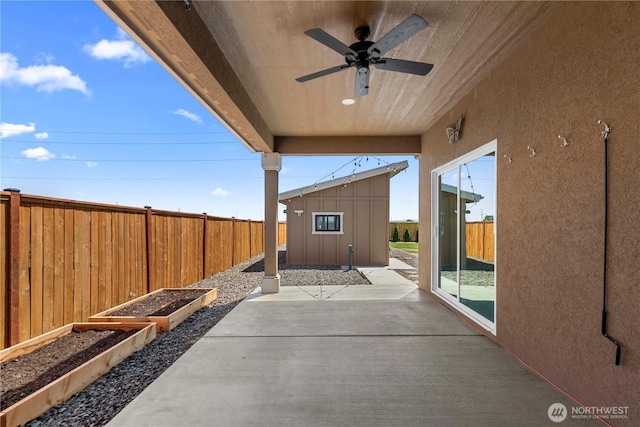 832 Q St SW, Quincy, WA 98848 - fenced backyard featuring a garden, a patio area, a ceiling fan, and an outbuilding