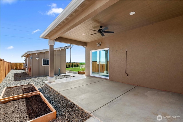 832 Q St SW, Quincy, WA 98848 - fenced backyard featuring ceiling fan, a vegetable garden, a patio area, and an outdoor structure