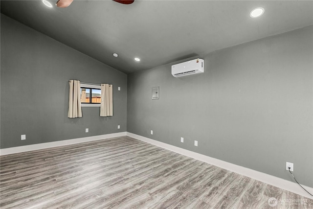832 Q St SW, Quincy, WA 98848 - empty room featuring a wall mounted air conditioner, wood finished floors, vaulted ceiling, recessed lighting, and ceiling fan