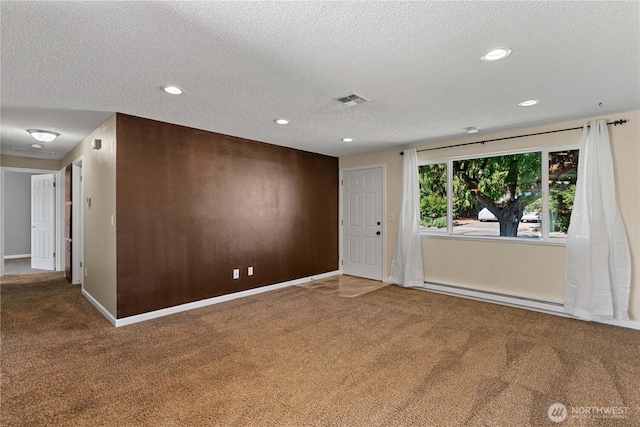 1315 Gaspar St, Wenatchee, WA 98801 - empty room with baseboard heating, carpet flooring, a textured ceiling, and recessed lighting