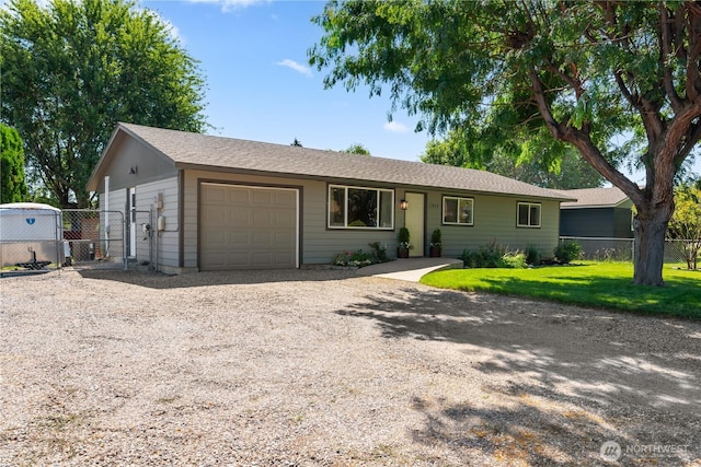 1315 Gaspar St, Wenatchee, WA 98801 - ranch-style home with gravel driveway, an attached garage, and a gate