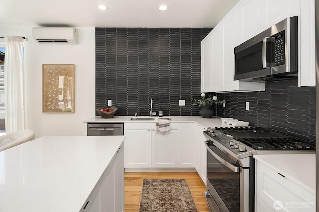 6042B 41st Ave SW, Seattle, WA 98136 - kitchen with stainless steel appliances, a wall mounted air conditioner, light wood-type flooring, white cabinetry, and recessed lighting
