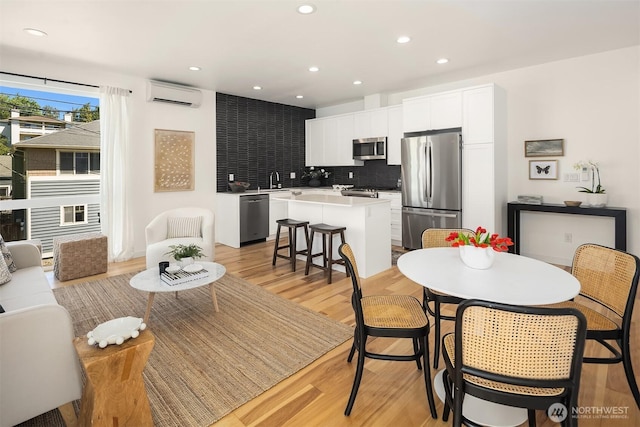 6042B 41st Ave SW, Seattle, WA 98136 - dining space featuring a wall mounted AC, light wood-style flooring, and recessed lighting