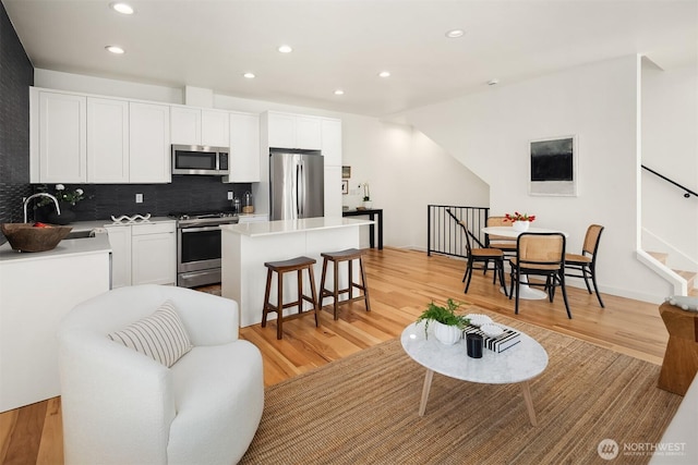 6042B 41st Ave SW, Seattle, WA 98136 - living room featuring recessed lighting, light wood-style flooring, and stairway