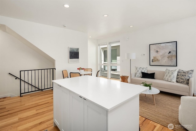 6042B 41st Ave SW, Seattle, WA 98136 - kitchen with light wood-style flooring, open floor plan, a center island, recessed lighting, and light countertops