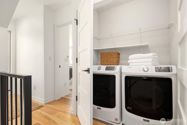 6042B 41st Ave SW, Seattle, WA 98136 - laundry area featuring washing machine and dryer and light wood finished floors