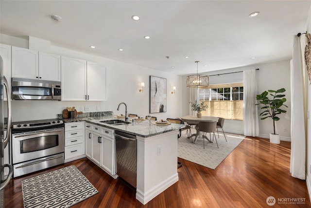 10909 Avondale Rd NE Unit L145, Redmond, WA 98052 - kitchen with appliances with stainless steel finishes, a peninsula, stone countertops, white cabinets, and recessed lighting