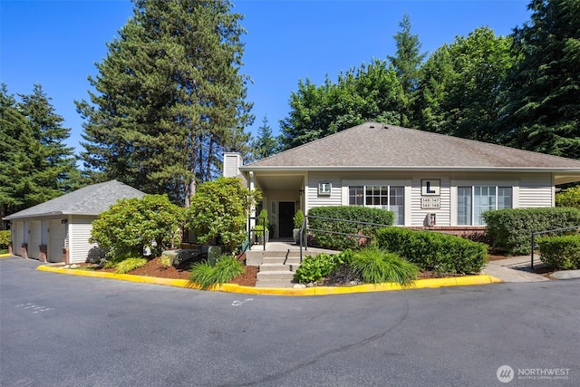 10909 Avondale Rd NE Unit L145, Redmond, WA 98052 - bungalow-style house featuring a chimney and an outdoor structure