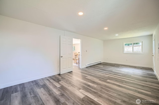 10985 SE 225th St, Kent, WA 98031 - spare room with baseboard heating, wood finished floors, and recessed lighting