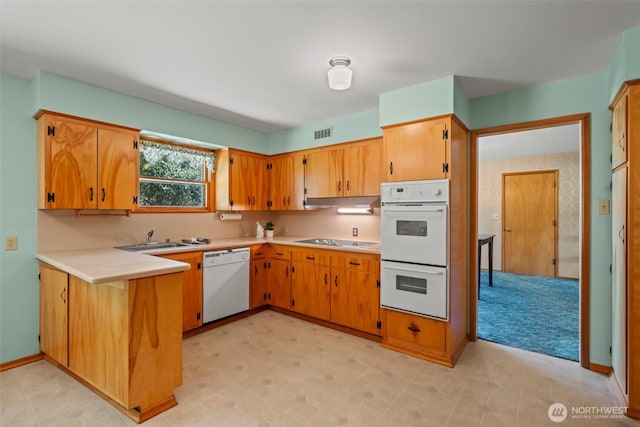 386 Mocliff Rd, Ephrata, WA 98823 - kitchen with white appliances, light countertops, and a peninsula