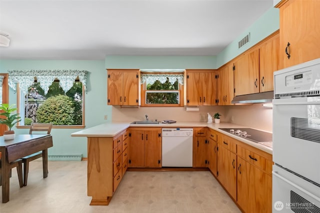 386 Mocliff Rd, Ephrata, WA 98823 - kitchen featuring white appliances, a peninsula, light countertops, under cabinet range hood, and light floors