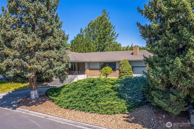 386 Mocliff Rd, Ephrata, WA 98823 - view of front of property featuring a chimney, a garage, stairs, and brick siding