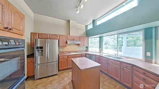 24250 164th Ave SE, Kent, WA 98042 - kitchen with stainless steel appliances, under cabinet range hood, a high ceiling, a kitchen island, and tasteful backsplash